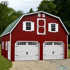 a red barn with two garage doors and windows