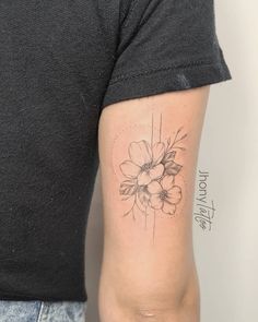 a woman's arm with a flower tattoo on the left side of her arm