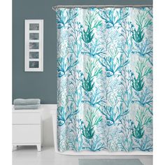 a shower curtain with blue and green corals on it in a white bathroom next to a toilet