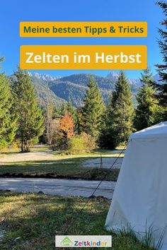 a tent in the middle of a field with mountains in the background and text overlay that reads meine best tips & tricks zelten im herbst