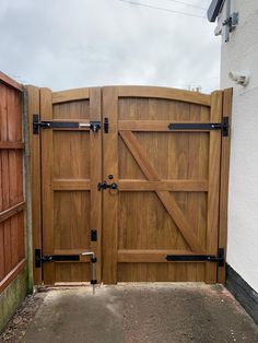 a wooden gate with black hardware on it