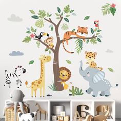 children's wall decals with jungle animals and trees on the walls in a playroom