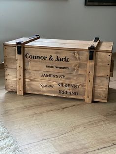 a large wooden box with two handles on the front and sides, sitting on top of a hard wood floor