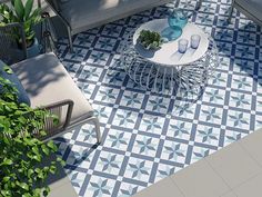 an aerial view of a patio with blue and white tiles on the floor, furniture and potted plants