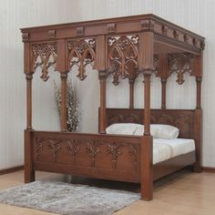 an ornate wooden bed frame in a room with hardwood flooring and white wallpaper