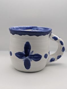 a blue and white coffee cup sitting on top of a table