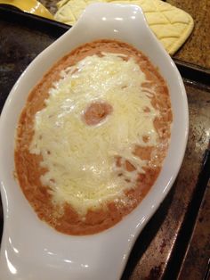 a white bowl filled with food on top of a stove