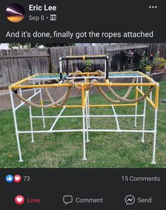 an upside down playground in the grass with yellow hoses attached to it's sides