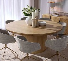 a dining room table with six chairs and a vase on the end, in front of a window