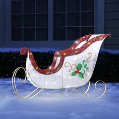 a white sleigh with red and green decorations