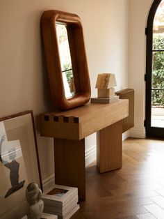 a wooden table with a mirror on top of it