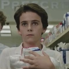 two people standing in a pharmacy aisle