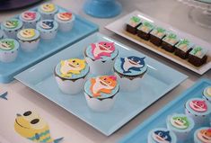 some cupcakes are sitting on blue trays