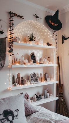 a white shelf filled with lots of halloween decorations on top of a bedroom wall next to a bed