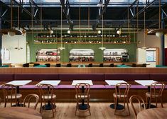 an empty restaurant with wooden tables and chairs