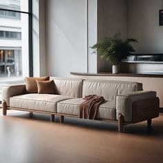 a couch sitting in front of a large window