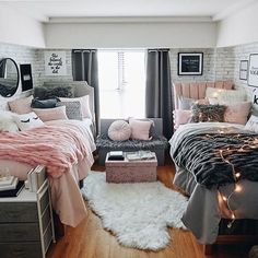 two beds in a room with pink and gray bedding, pillows and blankets on them