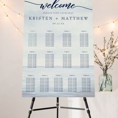 a wedding welcome sign on a tripod stand