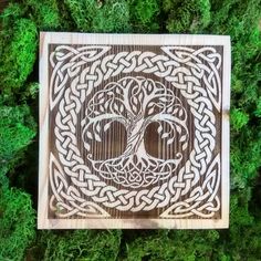 a wood carving with an image of a tree in the shape of a celtic knot