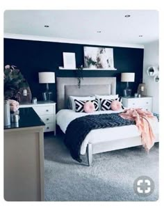 a bedroom decorated in black and white with pops of pink on the bed, nightstands