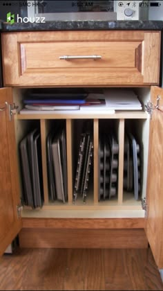 an open cabinet in the middle of a kitchen