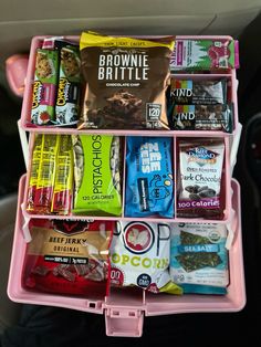 a pink car trunk filled with snacks and candy