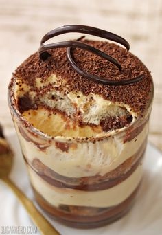 chocolate tirami dessert in a glass on a white plate with the words chocolate tirami written above it