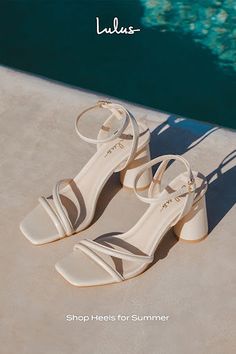 a pair of shoes sitting on top of a cement floor next to a swimming pool