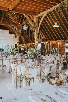 an indoor wedding venue with tables and chairs