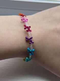 a woman's arm with a colorful bracelet on it