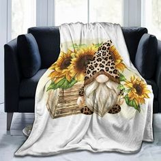 sunflowers and a gnome with a leopard print blanket on a couch in front of a window