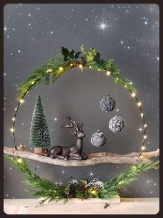 a wooden shelf with christmas decorations on top of it and lights hanging from the ceiling