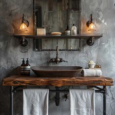 a bathroom sink sitting under a mirror on top of a wooden counter next to a towel rack