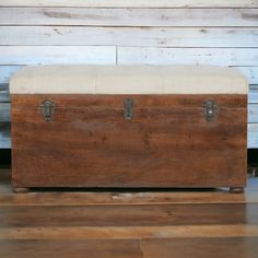 an old wooden trunk sitting on top of a hard wood floor