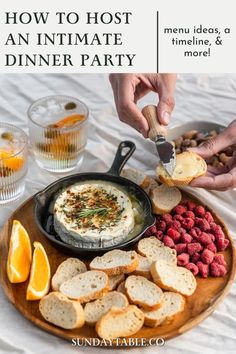 a plate with bread, crackers and raspberries on it that says how to host an intimate dinner party