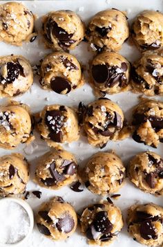 chocolate chip cookies are lined up on a baking sheet and ready to go into the oven