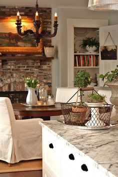 a kitchen with a marble counter top next to a dining room table