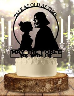 a star wars cake topper with a silhouette of darth vader and princess leisa