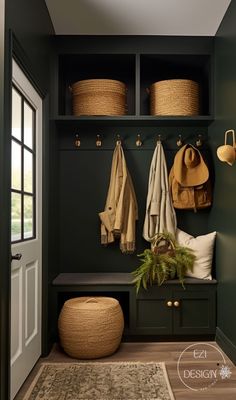 the entryway is decorated in green and has baskets, coat racks, and rugs