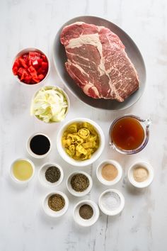 raw meat, spices and seasonings on a white table