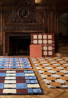 several pieces of art on the ground in front of a fire place with a fireplace