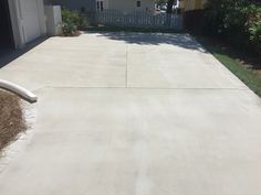 an empty driveway in front of a house