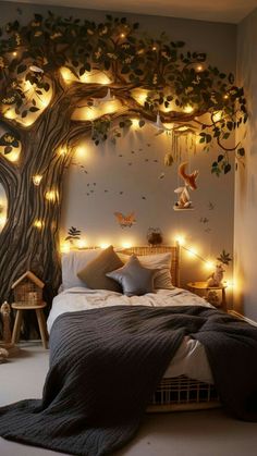 a bedroom decorated with lights and a tree wall mural on the wall above the bed