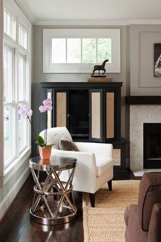 a living room filled with furniture and a fire place