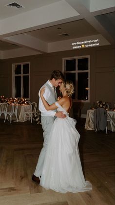 a bride and groom dance together at their wedding reception