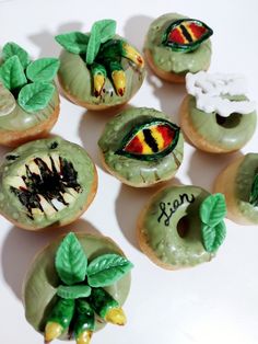 there are many decorated doughnuts with leaves and bugs on them that say may