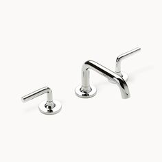 two chrome faucets on white background with no one around them in the photo