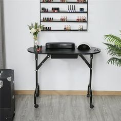 a black table with some bottles on it and a potted plant next to it