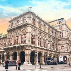 an old building with people standing in front of it