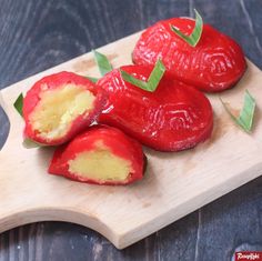 red peppers cut in half on a wooden cutting board